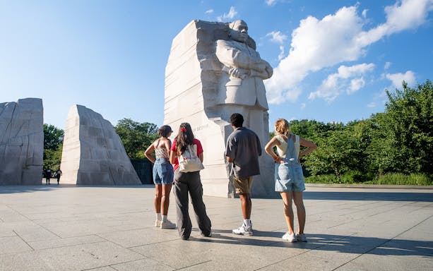 Visitors at Martin Luther King Jr. Memorial in Washington DC during electric cart tour.