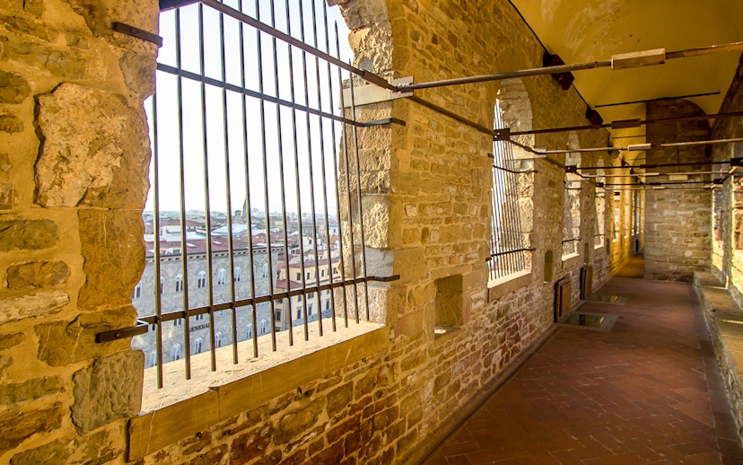 Long corridor with stone walls leading to the tower of Palazzo Vecchio, Florence, Tuscany.