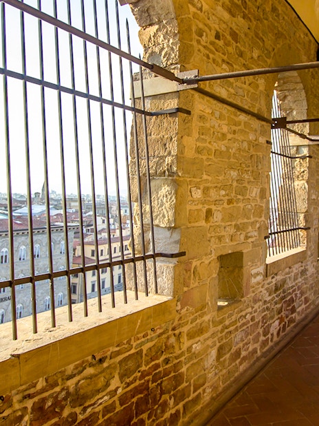 Long corridor with stone walls leading to the tower of Palazzo Vecchio, Florence, Tuscany.