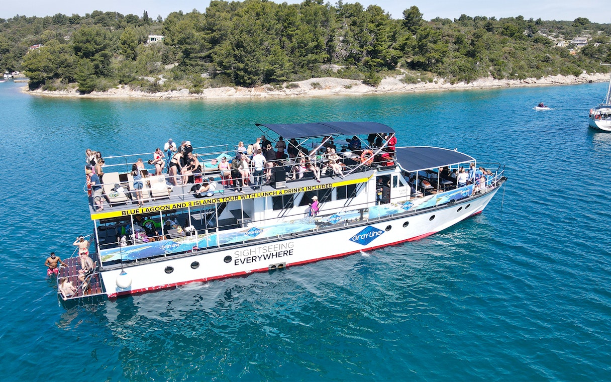 Cruise ship with tourists on Blue Lagoon tour near Split, Croatia.