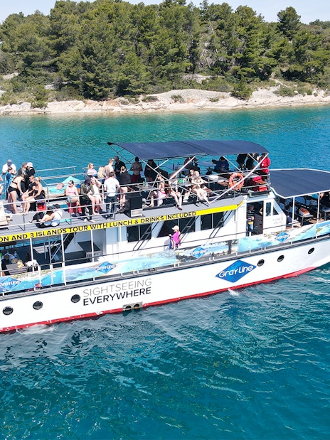 Cruise ship with tourists on Blue Lagoon tour near Split, Croatia.