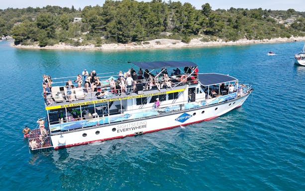 Cruise ship with tourists on Blue Lagoon tour near Split, Croatia.