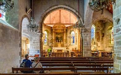 Interior of Church of Saint Pierre with altar and stained glass, Mont Saint Michel tour.