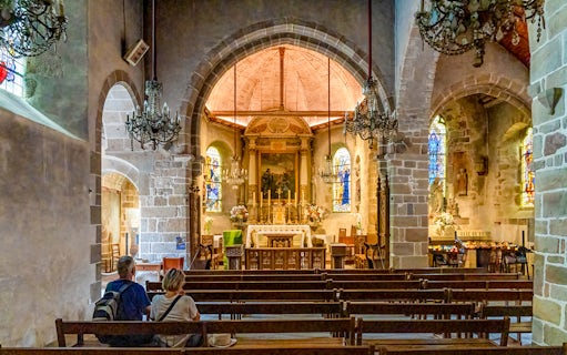 Interior of Church of Saint Pierre with altar and stained glass, Mont Saint Michel tour.