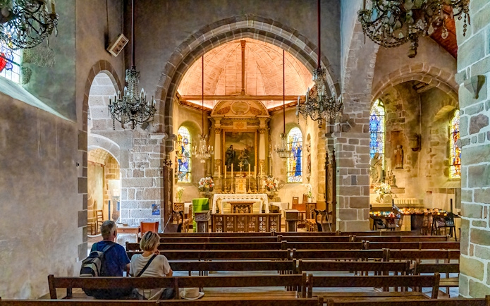 Interior of Church of Saint Pierre with altar and stained glass, Mont Saint Michel tour.