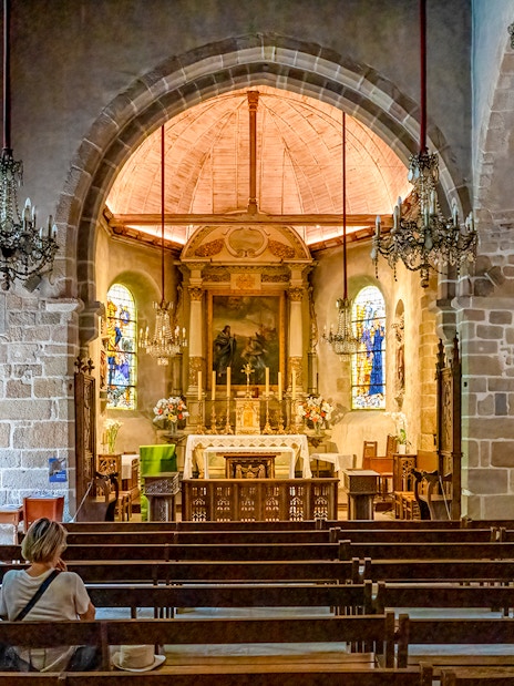 Interior of Church of Saint Pierre with altar and stained glass, Mont Saint Michel tour.