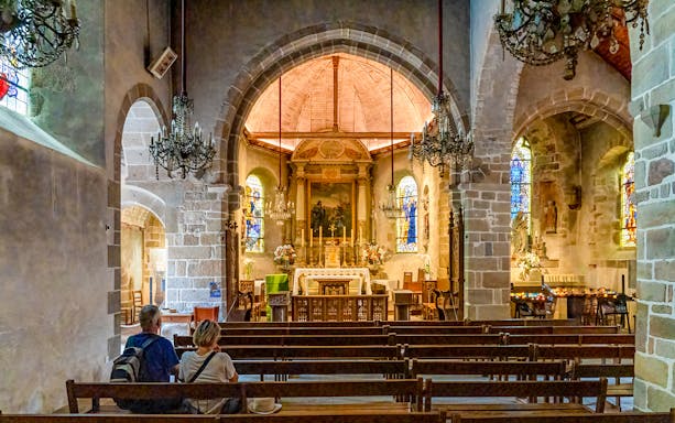 Interior of Church of Saint Pierre with altar and stained glass, Mont Saint Michel tour.