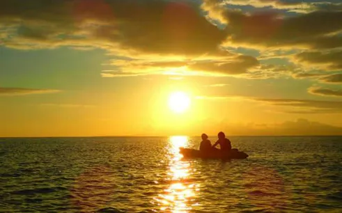 Kayakers on Iriomote Island at sunset, Okinawa.