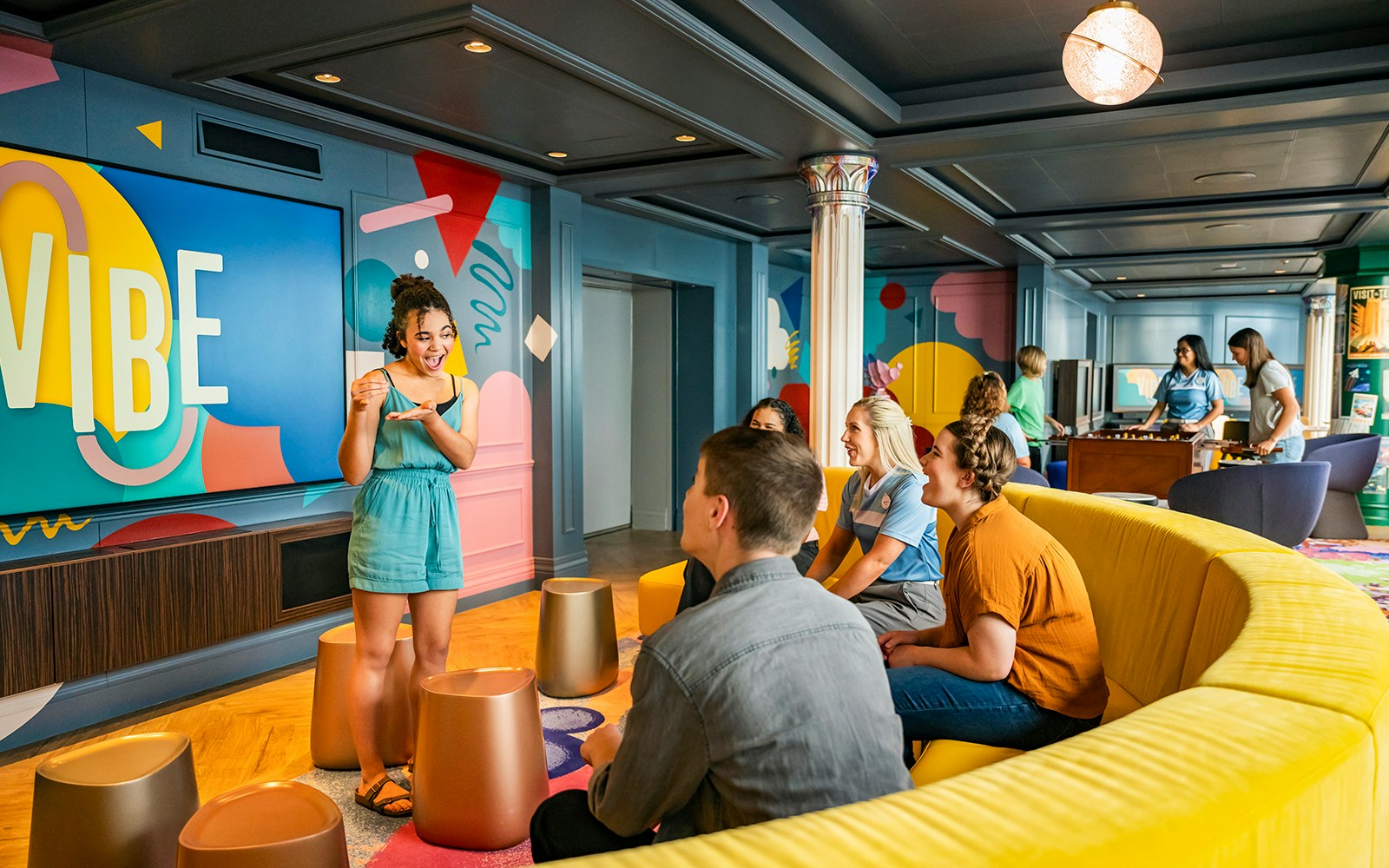 Teens enjoying activities at Vibe kids' club on a Disney cruise.