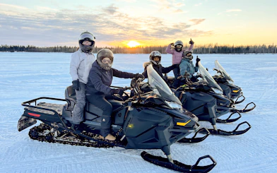 Group on snowmobiles during sunset tour in Fairbanks, Alaska.