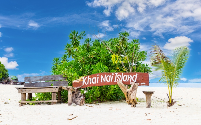 Khai Nai Island sign on sandy beach with tropical plants, part of Phuket 3 Khai Island tour.