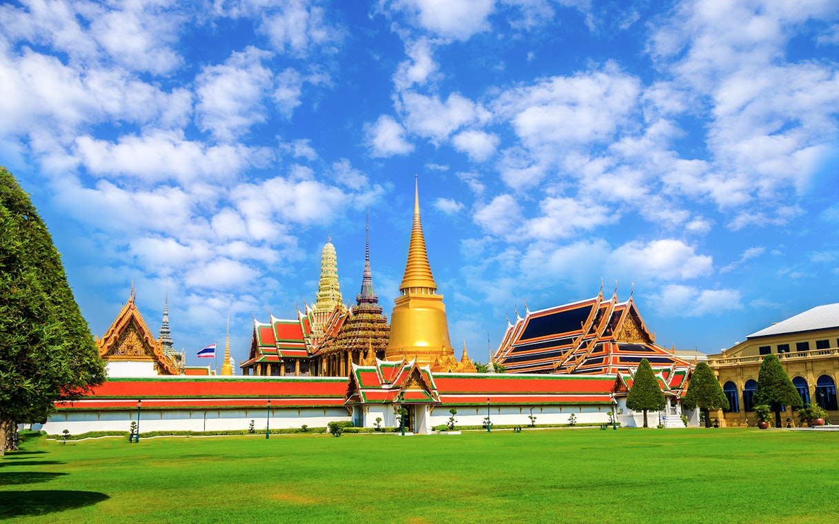 Wat Phra Kaew and Grand Palace complex in Bangkok with blue sky.
