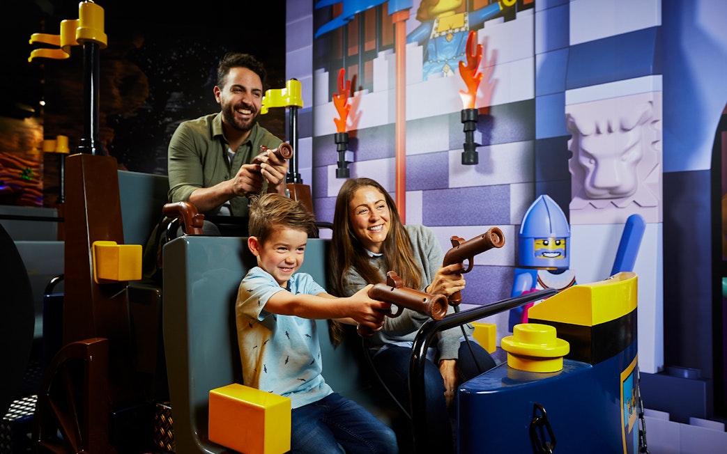 Family enjoying interactive ride at LEGOLAND Discovery Centre.