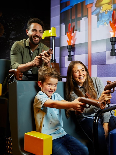Family enjoying interactive ride at LEGOLAND Discovery Centre.