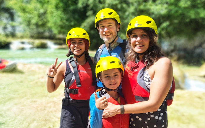 Family enjoying rafting at Mrežnica Canyon Waterfalls, Split.