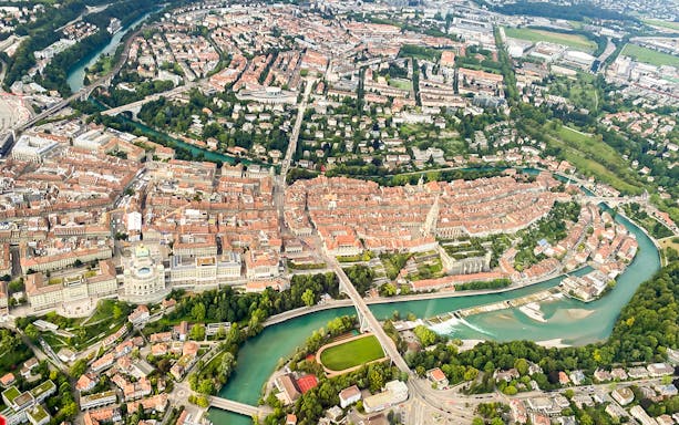 Aerial view of Bern, Switzerland, featuring the Aare River and historic city center.
