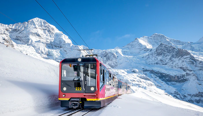 Train traveling through snowy Alps on route from Grindelwald to Jungfraujoch.