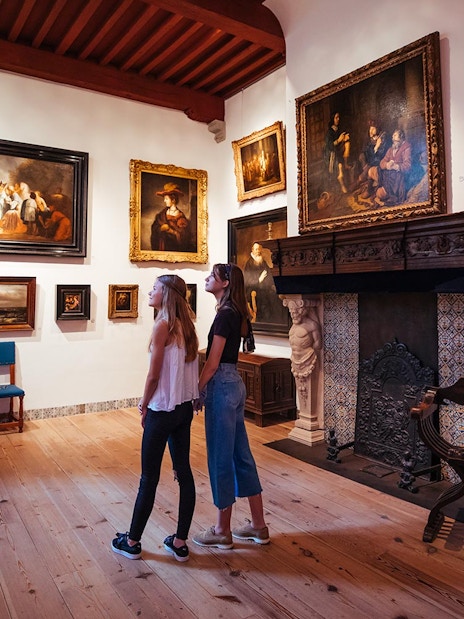 Guests exploring art in Rembrandt House Museum during a multimedia tour.