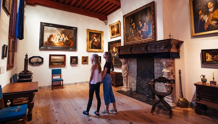 Visitors using multimedia guides at Rembrandt House Museum, Amsterdam.