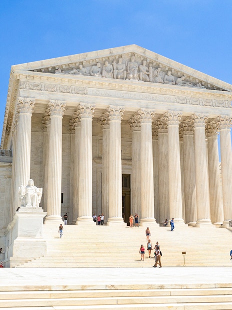 Supreme Court building with visitors on steps, Washington DC.
