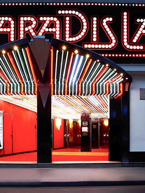 Paradis Latin entrance with illuminated marquee in Paris.