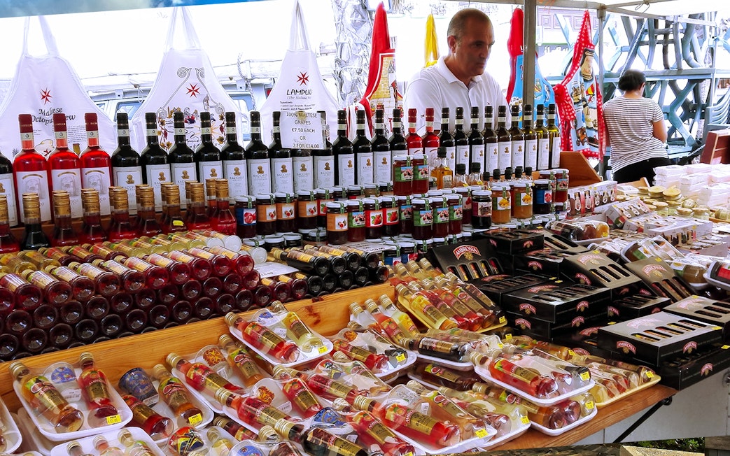 Stall with local wines and preserves at Marsaxlokk Sunday Market, Malta.