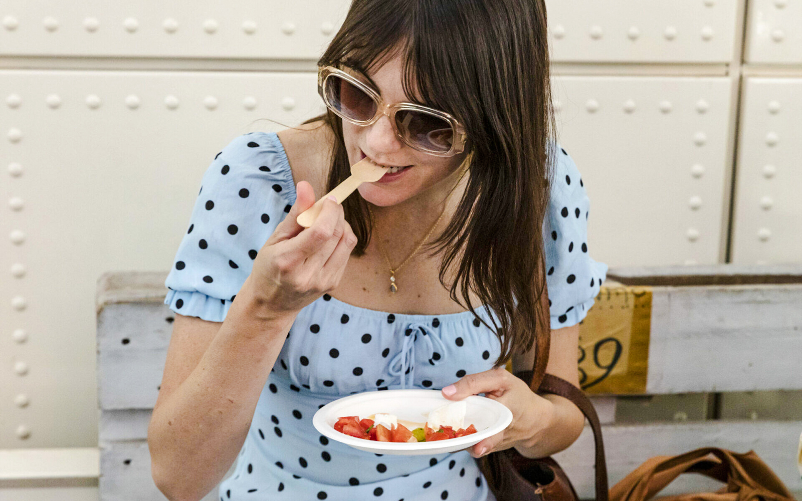 Woman enjoying food at Taste of Testaccio tour in Rome.