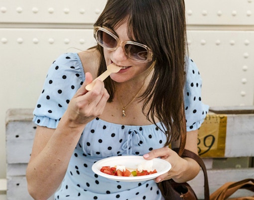 Woman enjoying food at Taste of Testaccio tour in Rome.