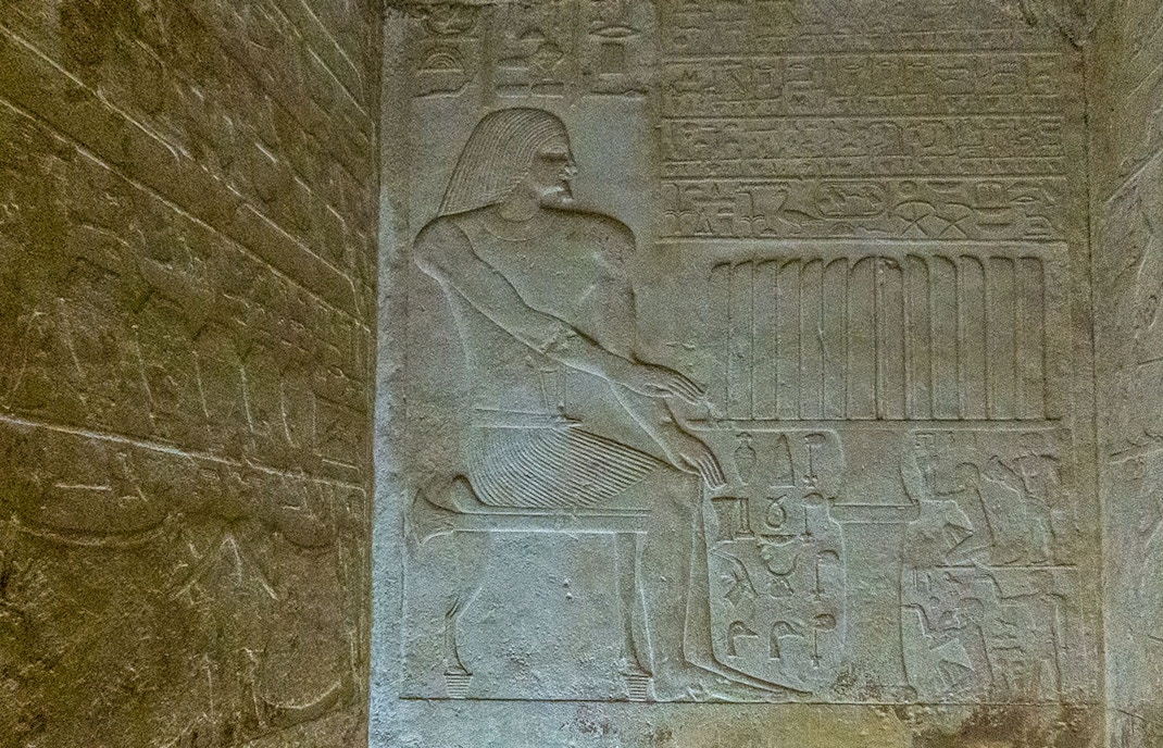 Bas relief depicting a seated figure with hieroglyphs in the Pyramid of Queen Meritetis I, Giza Necropolis, Cairo.