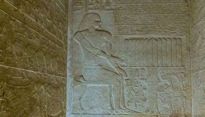 Bas relief depicting a seated figure with hieroglyphs in the Pyramid of Queen Meritetis I, Giza Necropolis, Cairo.