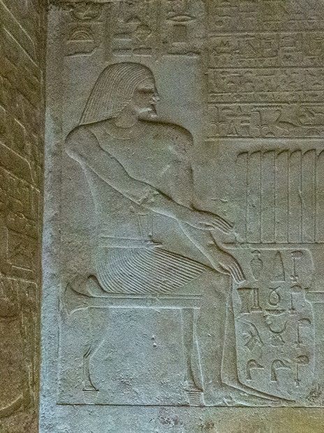 Bas relief depicting a seated figure with hieroglyphs in the Pyramid of Queen Meritetis I, Giza Necropolis, Cairo.