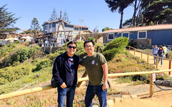 Visitors at Isla Negra with Pablo Neruda's house in the background, part of the Santiago day tour.