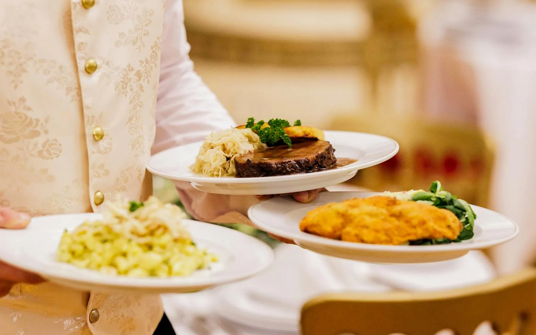 Server presenting gourmet dishes at Imperial Gala Concert, Palais Auersperg, Vienna.