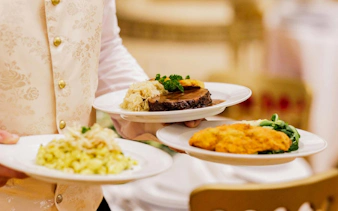 Server presenting gourmet dishes at Imperial Gala Concert, Palais Auersperg, Vienna.