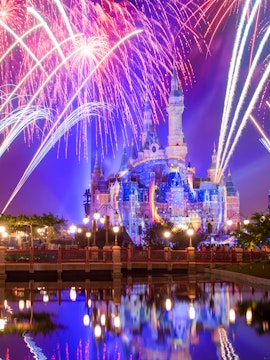 Sleeping Beauty Castle with fireworks at night, Disneyland Shanghai.