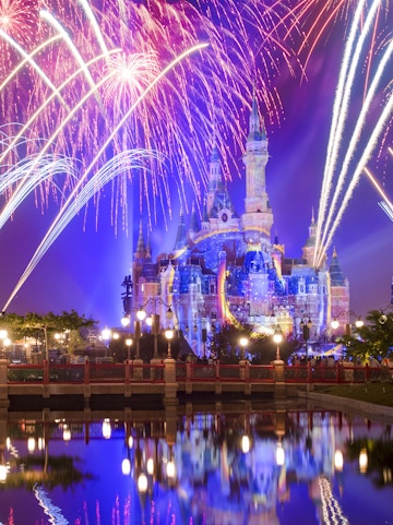 Sleeping Beauty Castle with fireworks at night, Disneyland Shanghai.