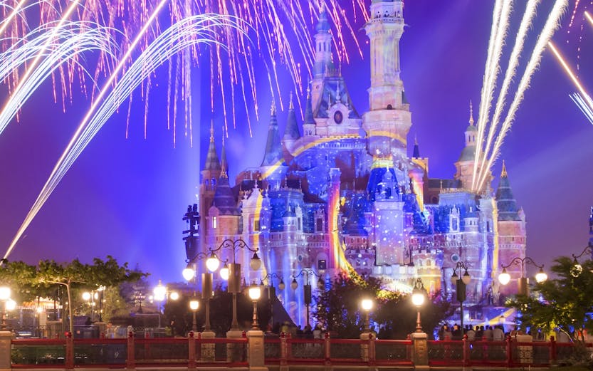 Sleeping Beauty Castle with fireworks at night, Disneyland Shanghai.