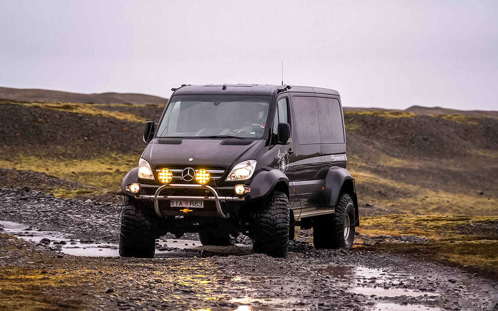 Off-road vehicle on rocky terrain during Crystal Ice Cave Tour.