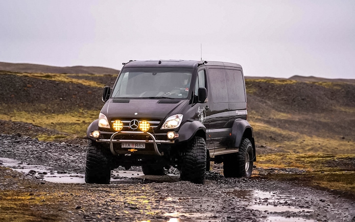 Off-road vehicle on rocky terrain during Crystal Ice Cave Tour.