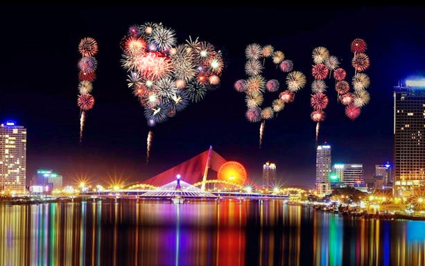 Fireworks spelling "I ♥ DN" over Da Nang skyline during International Fireworks Festival.