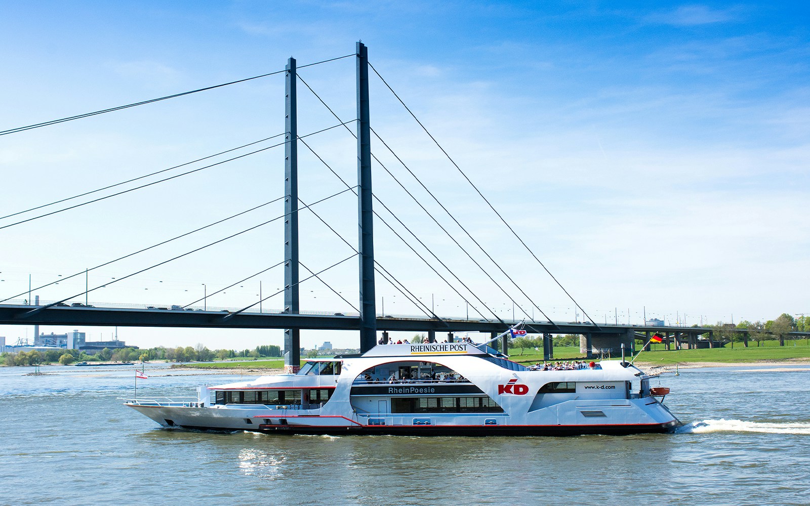 RheinPoesie ship cruising on the Rhine River with Düsseldorf skyline in the background.