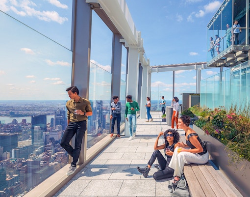 Visitors enjoying the view from Summit One Vanderbilt's outdoor terrace in New York City.