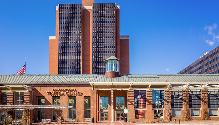 Philadelphia Independence Visitor Center with American flag and modern architecture.