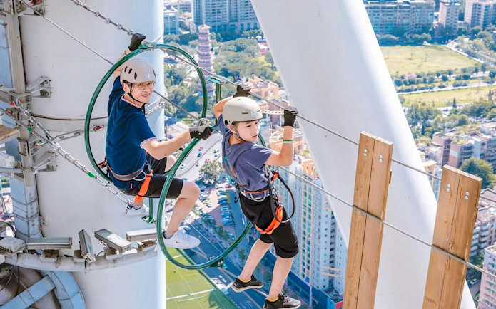 Visitors navigating a high-altitude course at Alpha Discovery Park, Canton Tower, Guangzhou.