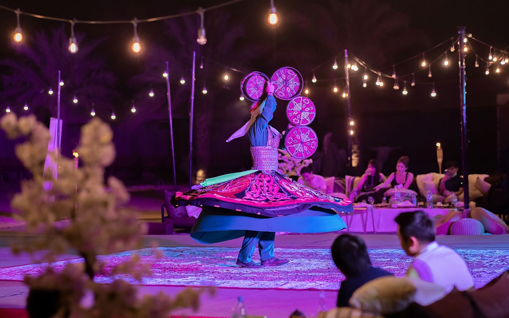 Dancer performing traditional Tanoura dance during Abu Dhabi Evening Desert Safari.