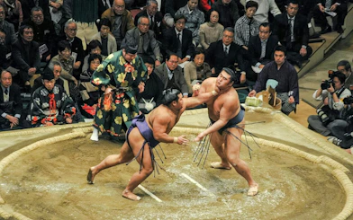 Sumo wrestlers competing at Grand Sumo Tournament in Japan.