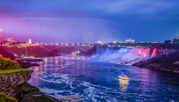 Niagara Falls boat tour with mist and rainbow, Ontario, Canada.