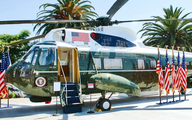 Presidential helicopter on display with American flags, used by four U.S. Presidents.