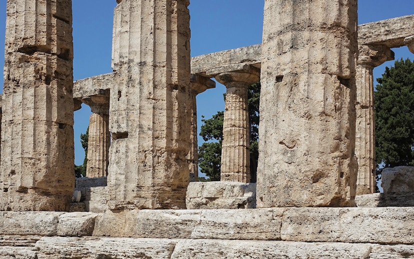 Ancient stone columns at Paestum Archaeological Site, Italy.