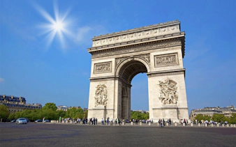 Arc de Triomphe in Paris on a sunny day, part of a day trip with Eiffel Tower lunch.